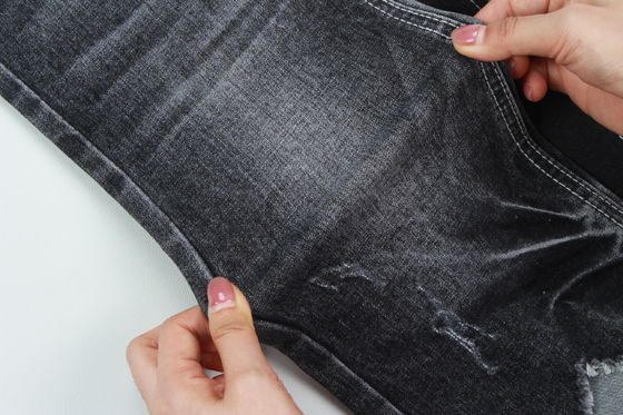 Tejido vaquero elástico jaspeado negro oscuro de calidad superior para jeans