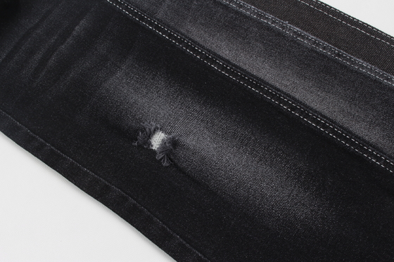 Color del negro de la tela del dril de algodón del alto elástico 11.5Oz con el rollo blanco de la parte trasera para los vaqueros del hombre